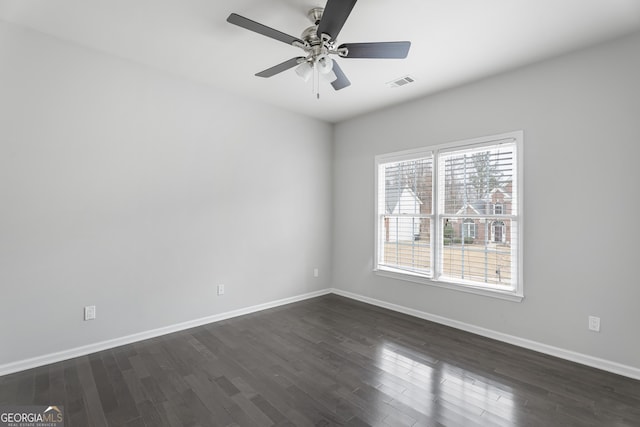 empty room featuring ceiling fan and dark hardwood / wood-style floors