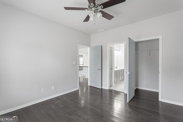 unfurnished bedroom with ceiling fan, dark hardwood / wood-style flooring, connected bathroom, and a closet