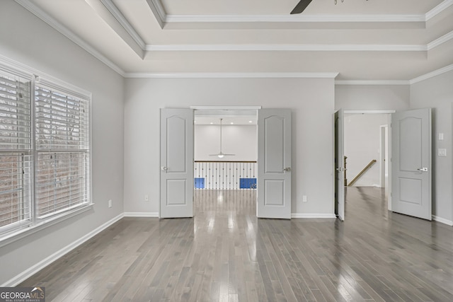 spare room featuring ceiling fan, wood-type flooring, and crown molding