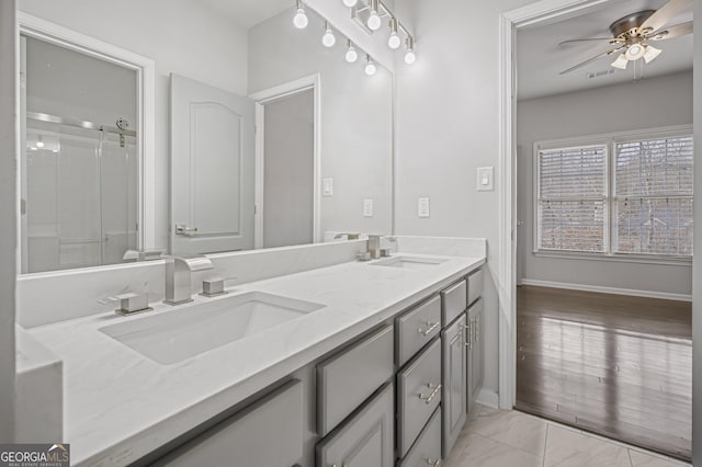 bathroom with vanity, a shower with door, and ceiling fan