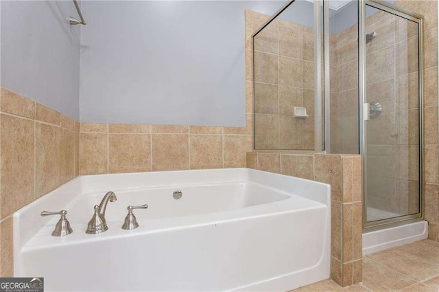 bathroom with tile patterned floors and separate shower and tub