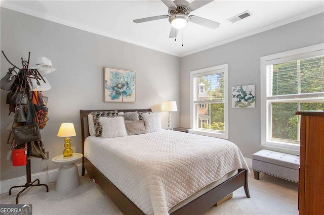 carpeted bedroom featuring ceiling fan and ornamental molding