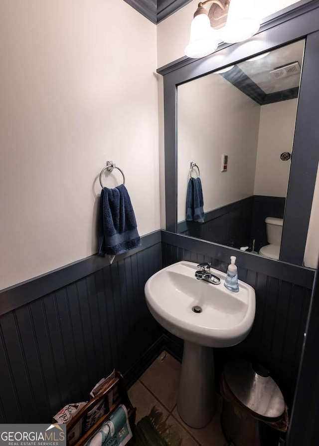 bathroom with tile patterned flooring, toilet, and sink