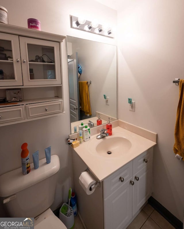 bathroom with tile patterned flooring, vanity, and toilet