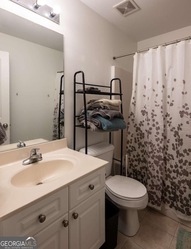 bathroom with curtained shower, tile patterned flooring, vanity, and toilet