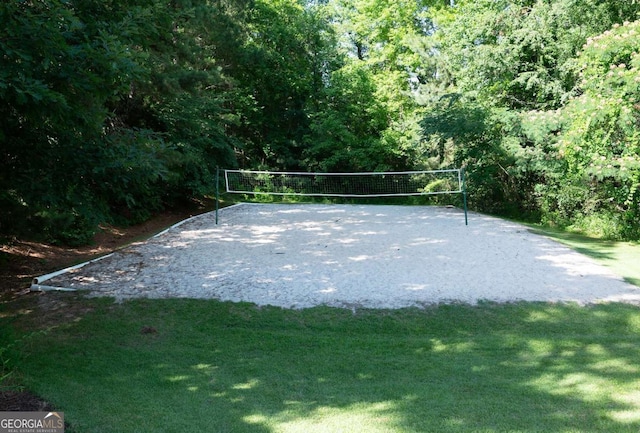 view of home's community featuring volleyball court and a yard