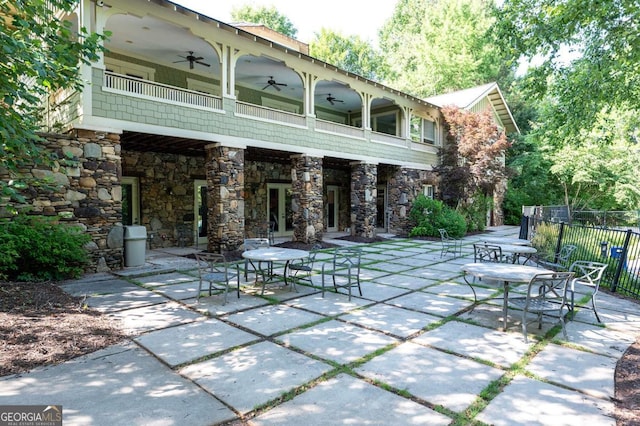 view of patio / terrace with ceiling fan and a balcony