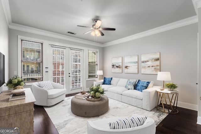 living room featuring dark hardwood / wood-style floors, a wealth of natural light, and crown molding