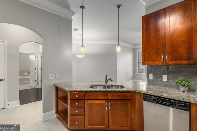 kitchen featuring light stone counters, sink, light tile patterned floors, decorative light fixtures, and dishwasher