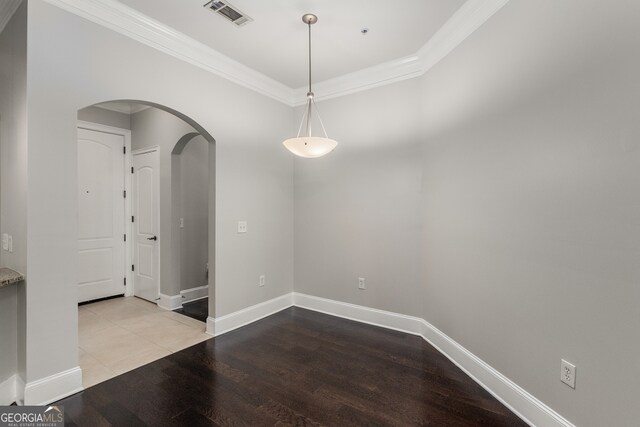 tiled spare room featuring crown molding