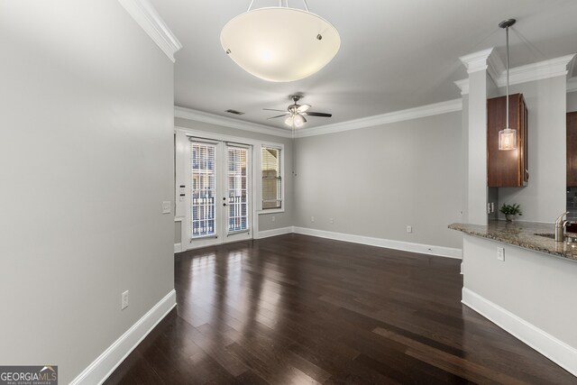 unfurnished living room featuring ceiling fan, ornamental molding, sink, and french doors