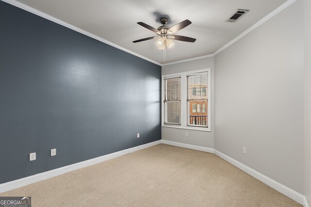 carpeted spare room featuring ceiling fan and crown molding