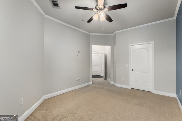 unfurnished bedroom with ceiling fan, light colored carpet, and ornamental molding