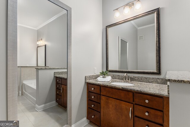 bathroom featuring tile patterned floors, a tub, crown molding, and vanity