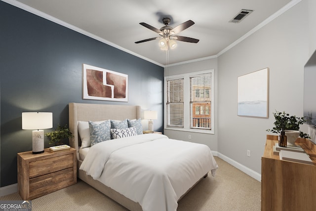 carpeted bedroom featuring ceiling fan and crown molding