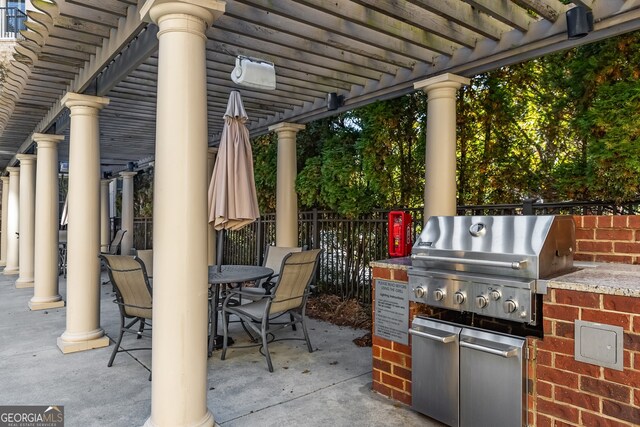 view of patio / terrace featuring an outdoor kitchen, a pergola, and a grill