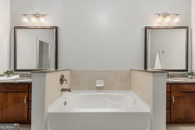 bathroom featuring vanity and a tub