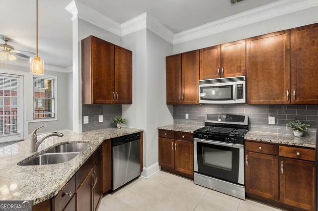 kitchen with appliances with stainless steel finishes, backsplash, light tile patterned floors, and sink