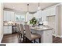 kitchen with white cabinets, pendant lighting, and a kitchen breakfast bar