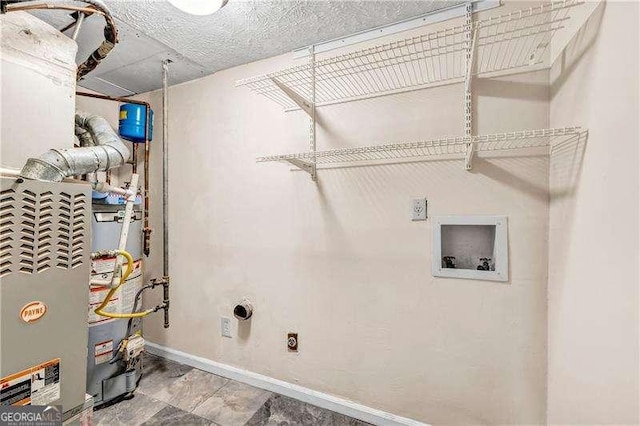 laundry room featuring electric dryer hookup, hookup for a washing machine, and gas water heater