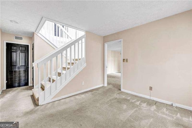 interior space with carpet and a textured ceiling