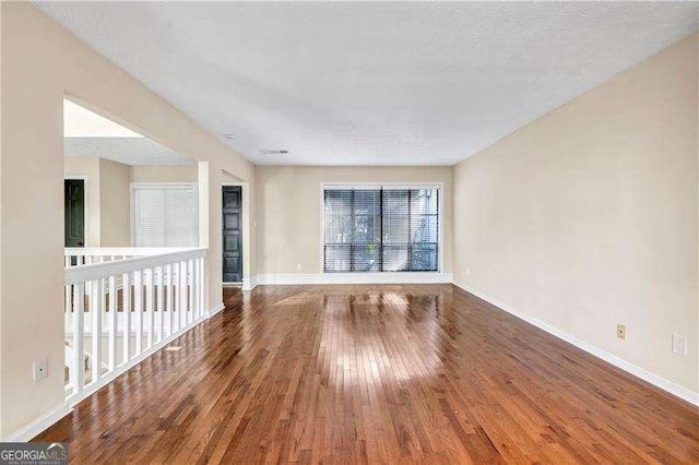 empty room with hardwood / wood-style flooring