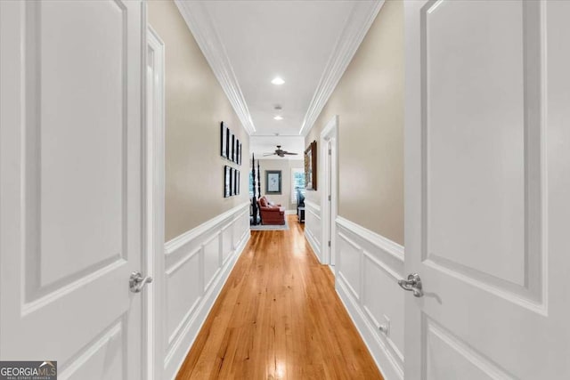 hall featuring crown molding and light hardwood / wood-style flooring