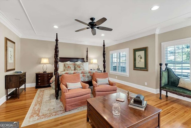 bedroom featuring ceiling fan, light hardwood / wood-style floors, and crown molding