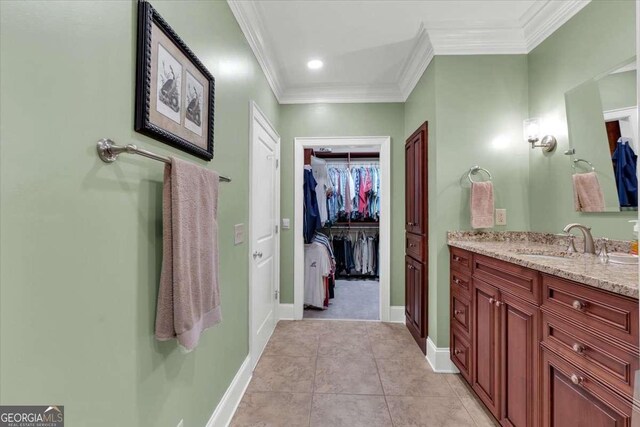 bathroom with tile patterned floors, vanity, and crown molding