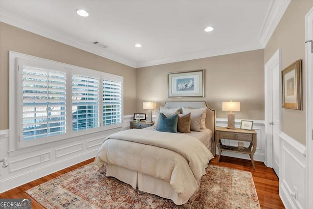 bedroom featuring hardwood / wood-style floors and ornamental molding