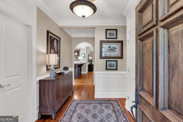 hallway with hardwood / wood-style floors and ornamental molding