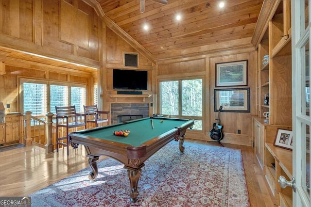 game room featuring wooden walls, light hardwood / wood-style flooring, wood ceiling, and billiards