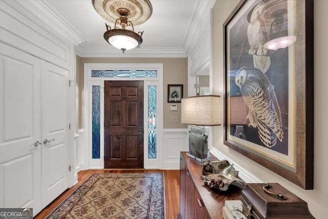 foyer with dark hardwood / wood-style flooring and ornamental molding