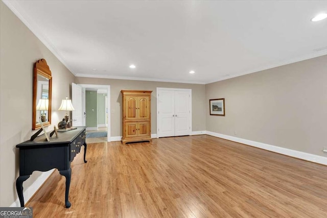 interior space with ornamental molding and light wood-type flooring