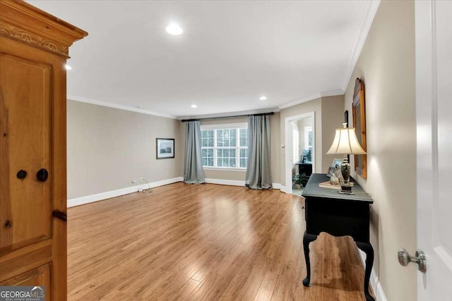 interior space with light hardwood / wood-style flooring and crown molding