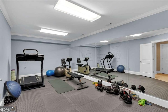 exercise area featuring crown molding