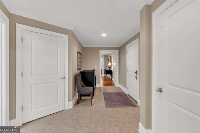 hall featuring light tile patterned floors and ornamental molding