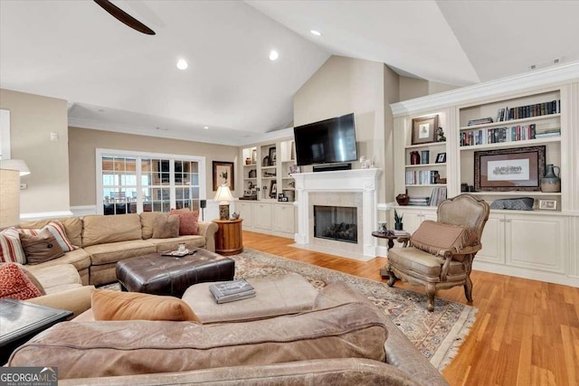 living room with ceiling fan, built in features, high vaulted ceiling, and light hardwood / wood-style flooring