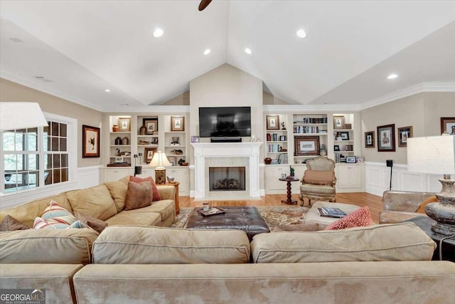 living room with crown molding, built in features, and light wood-type flooring