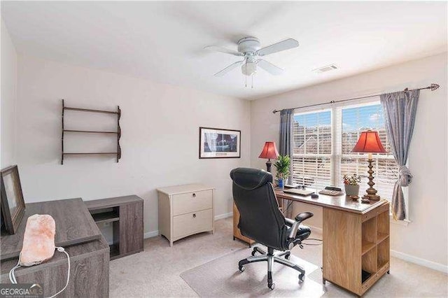 home office with ceiling fan and light carpet