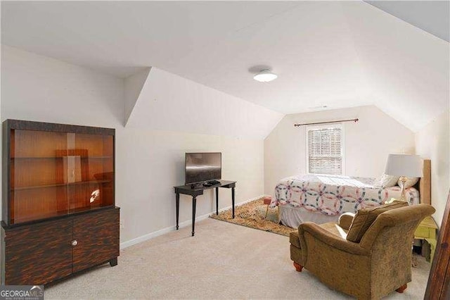 bedroom featuring light carpet and lofted ceiling