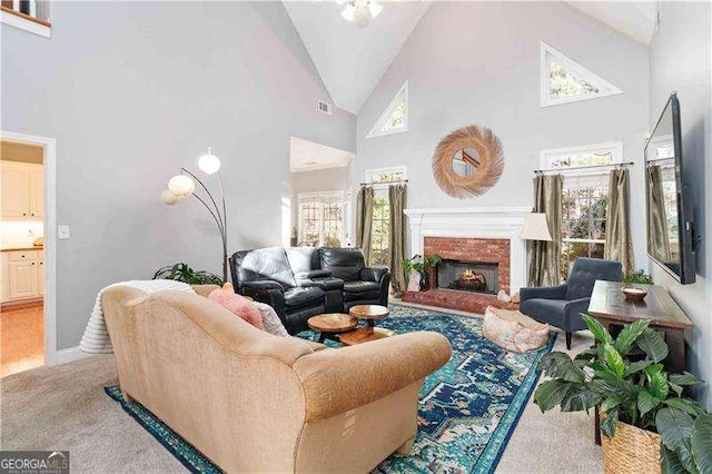 carpeted living room featuring high vaulted ceiling and plenty of natural light