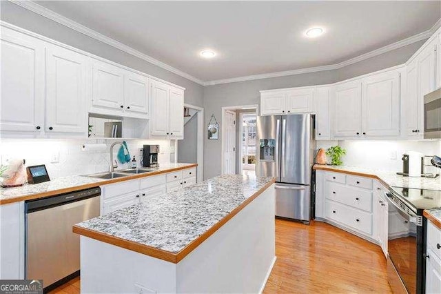 kitchen featuring white cabinets, stainless steel appliances, and a kitchen island