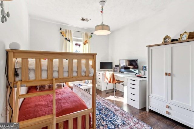 bedroom with dark wood-type flooring