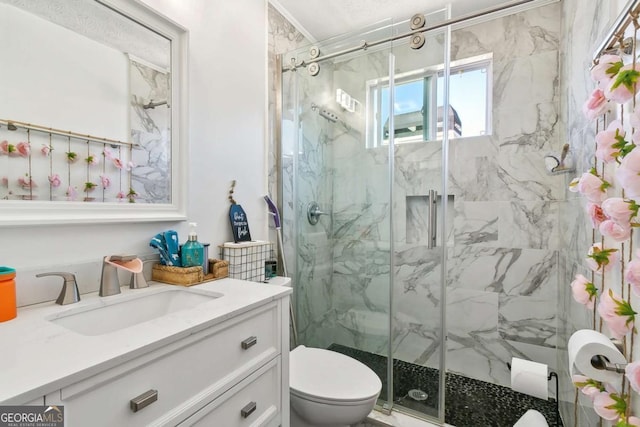 bathroom featuring vanity, toilet, and a shower with door