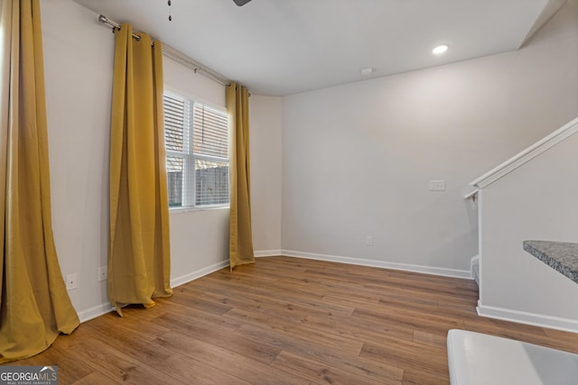 empty room featuring light wood-type flooring and ceiling fan