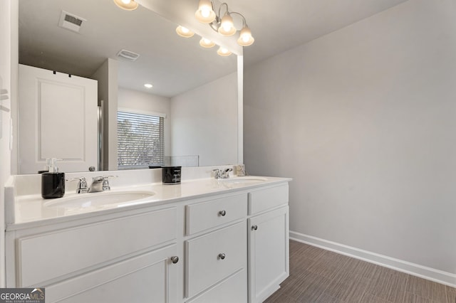 bathroom featuring a notable chandelier and vanity