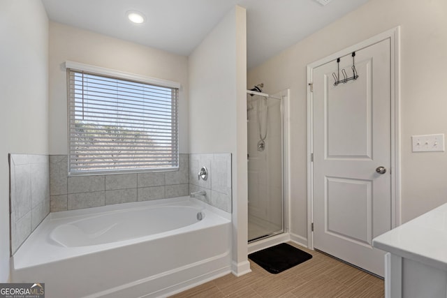 bathroom featuring vanity and plus walk in shower