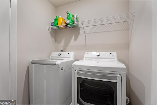 washroom with washing machine and clothes dryer