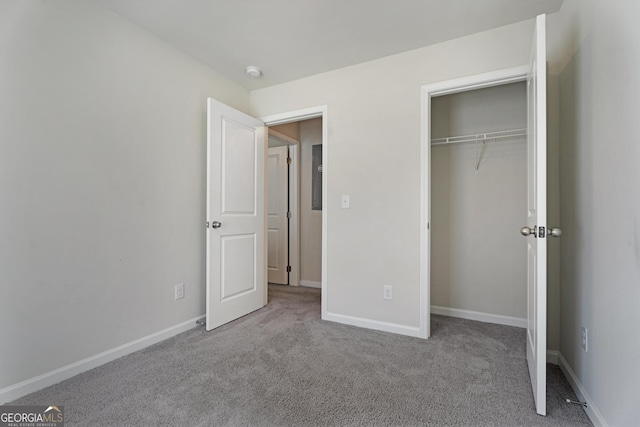 unfurnished bedroom with light carpet and a closet